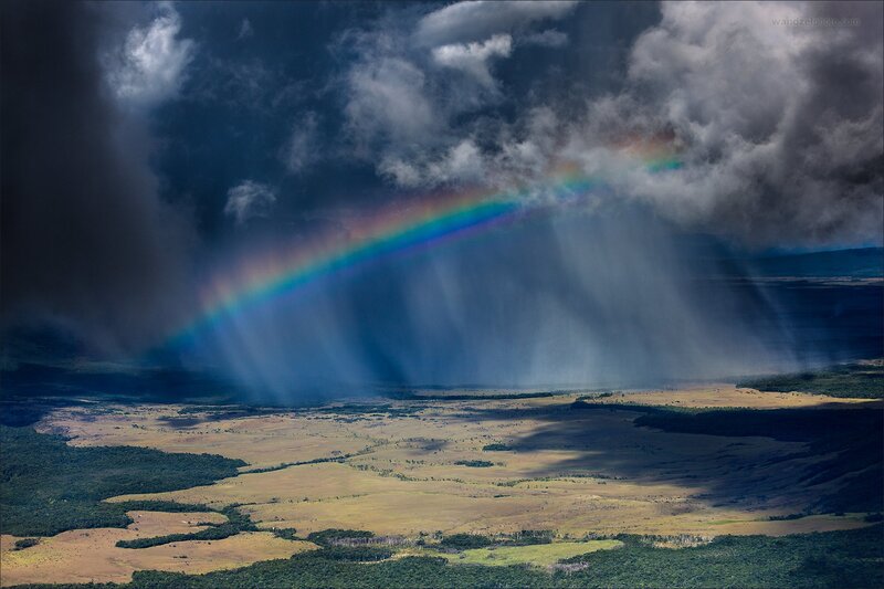 Rainbow over stormy landscape