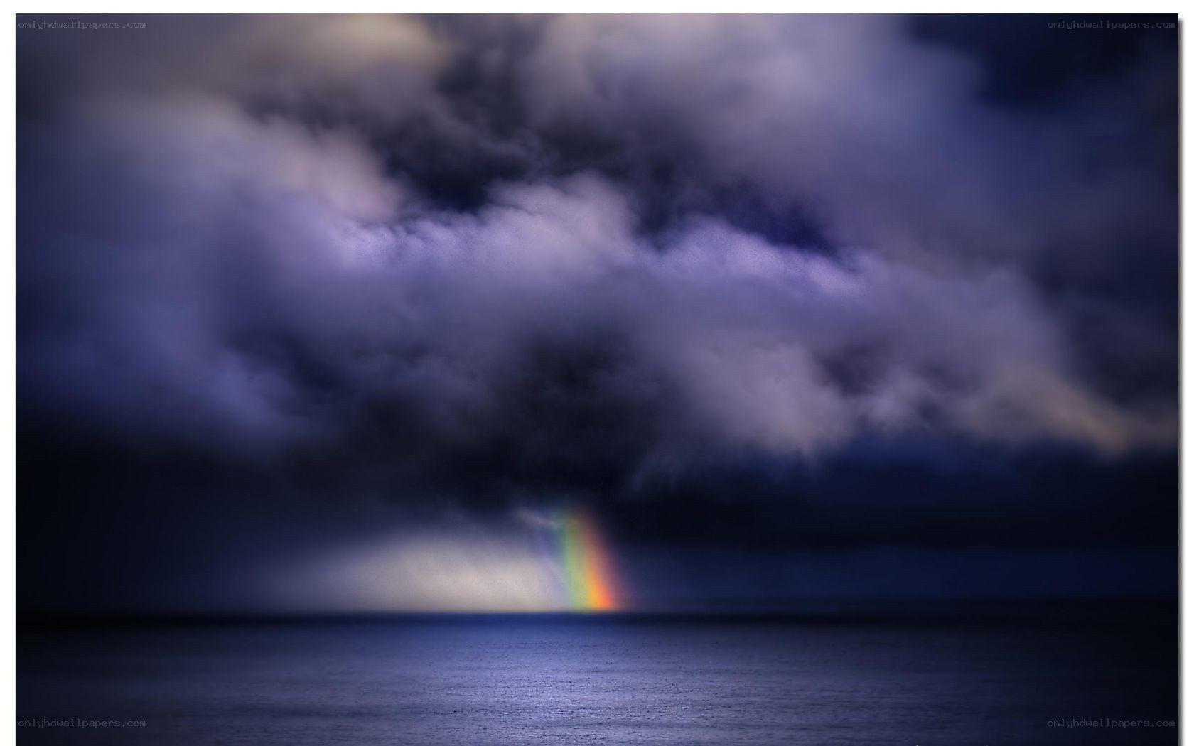 Rainbow over stormy sea