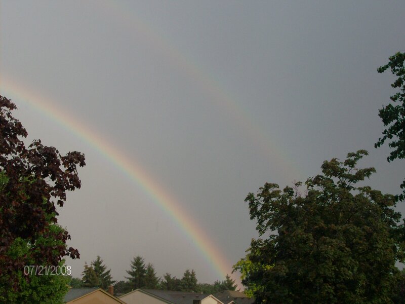 Rainbow over suburban homes