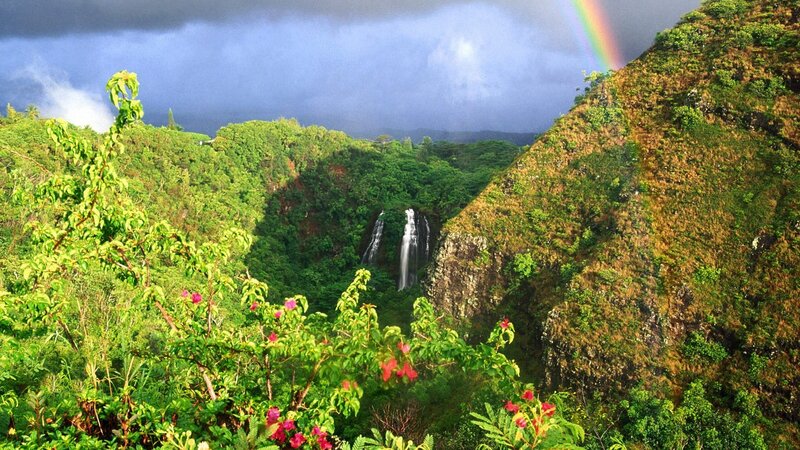 Rainbow over tropical waterfall