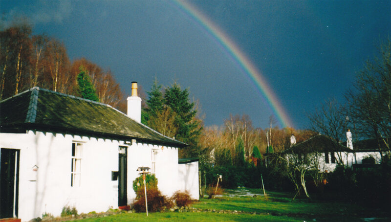 Rainbow over white cottage
