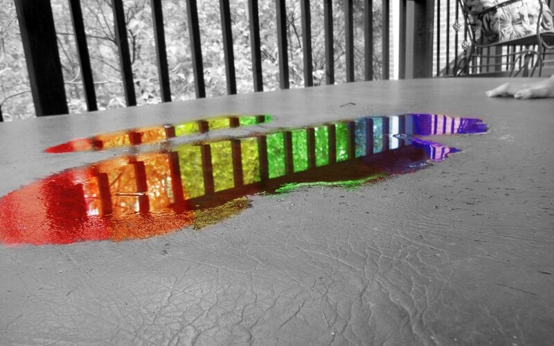 rainbow reflection on wet surface