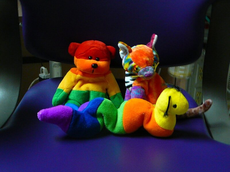 Rainbow stuffed animals on chair
