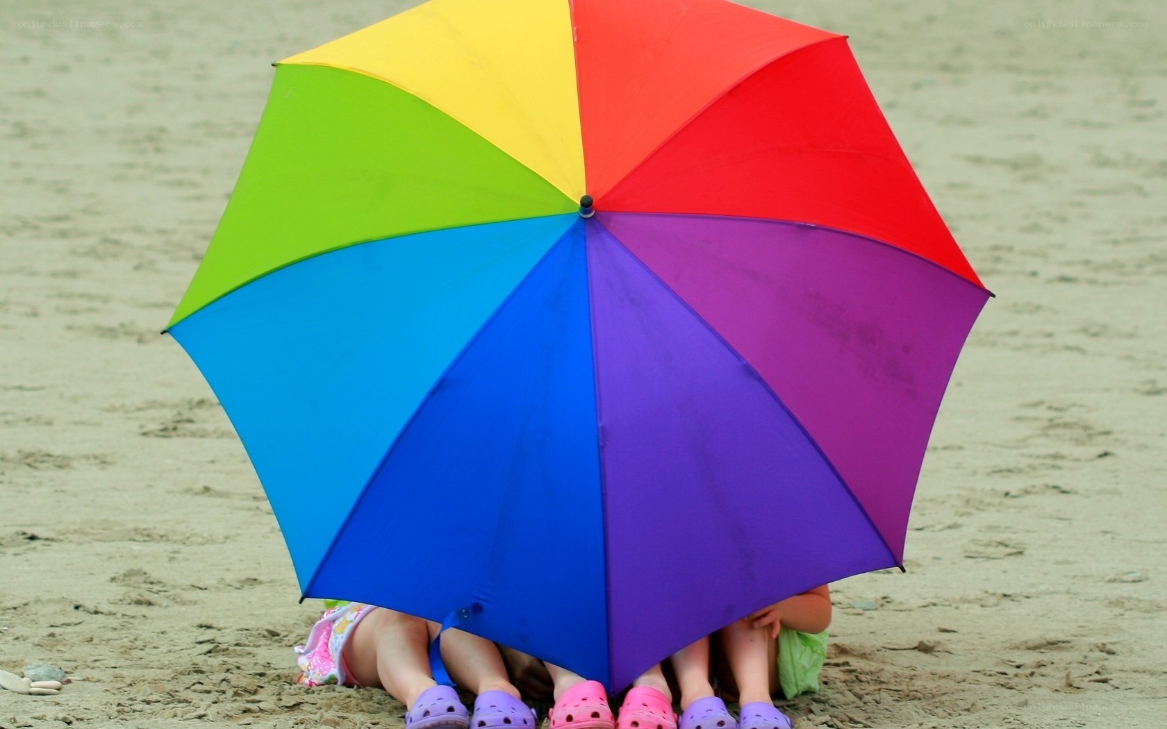 Rainbow umbrella on beach