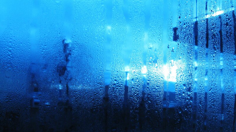Raindrops on a blue glass surface