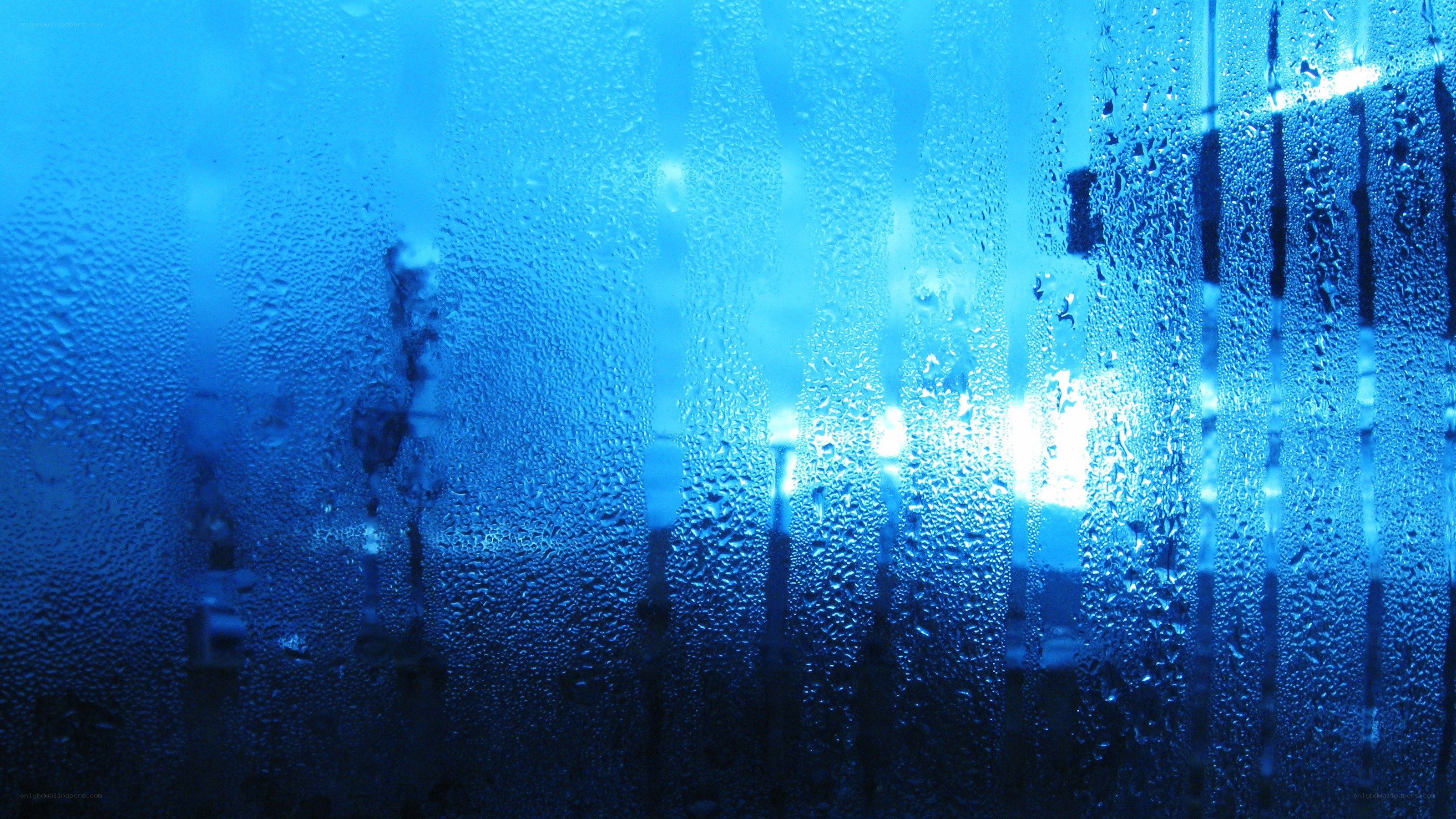 Raindrops on a blue glass surface