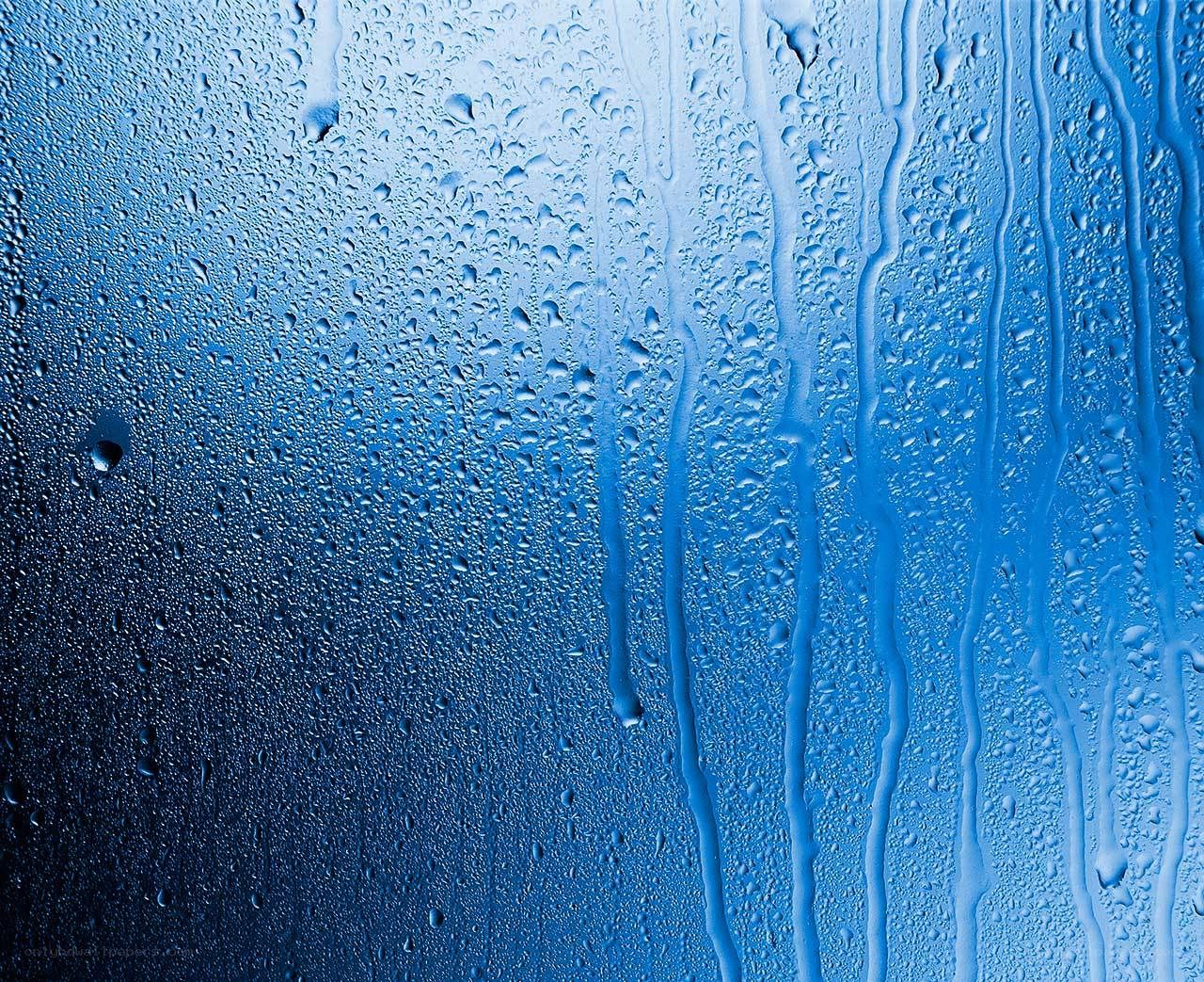 Raindrops on a blue glass surface