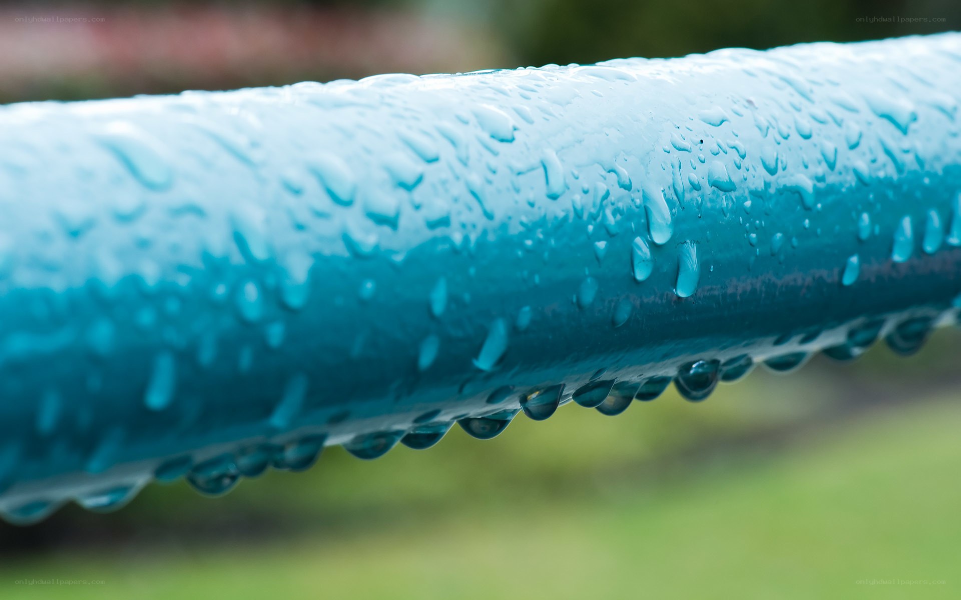 Raindrops on a blue pipe