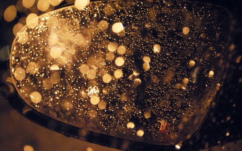 raindrops on a car mirror