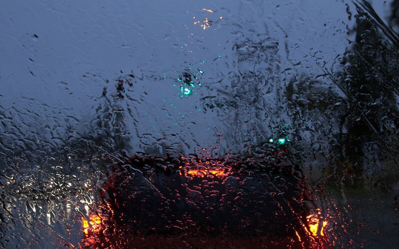 Raindrops on a car window at night