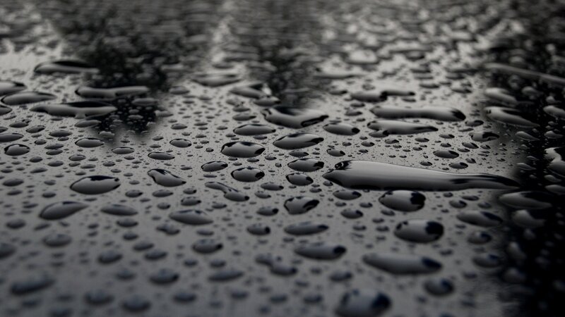 Raindrops on a dark surface