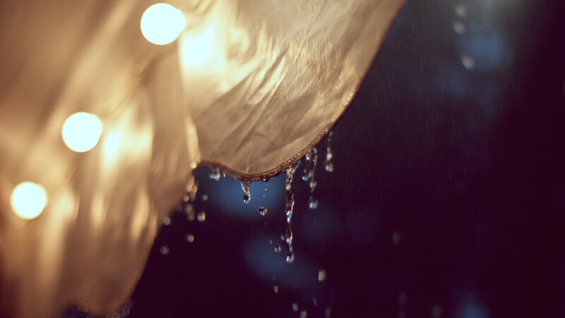 raindrops on a lit umbrella