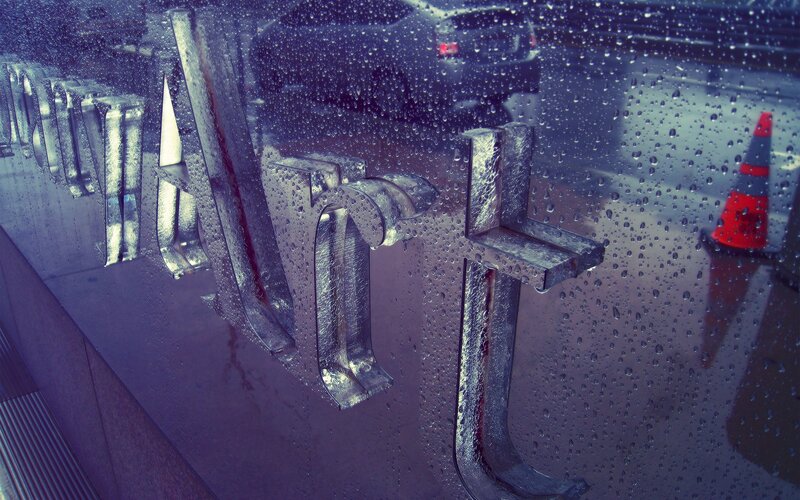 Raindrops on a wet sign