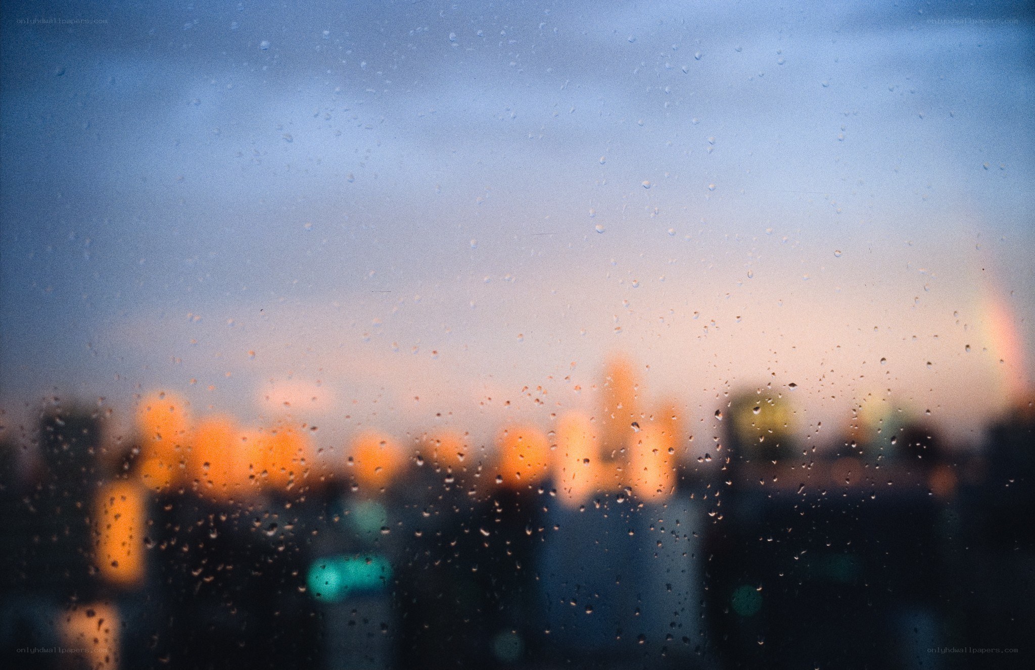 raindrops on a window at dusk