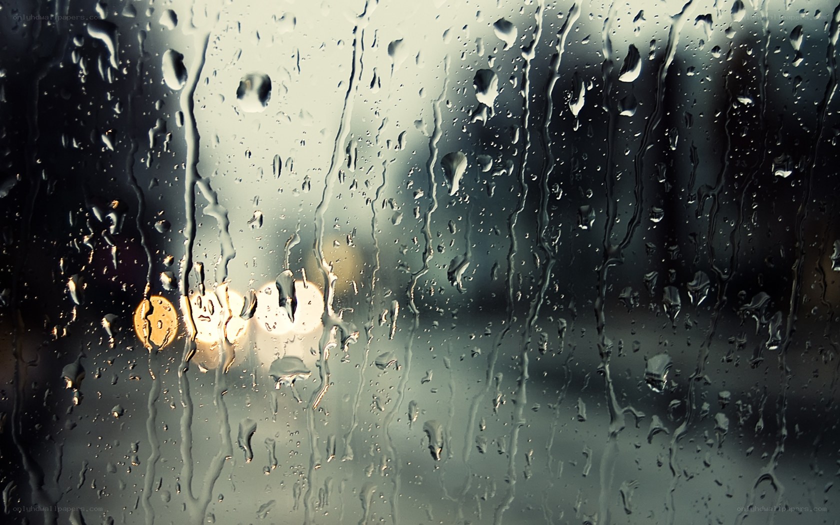 Raindrops on a window at night