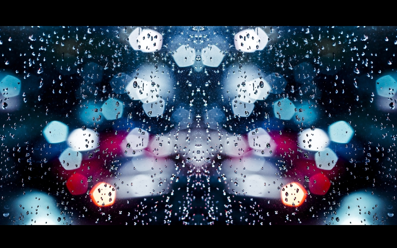 Raindrops on a window at night