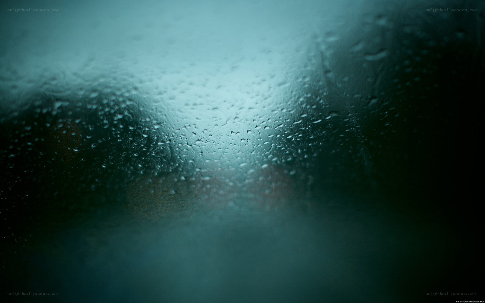 Raindrops on a window at night