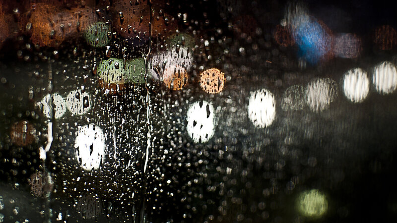 Raindrops on a window at night