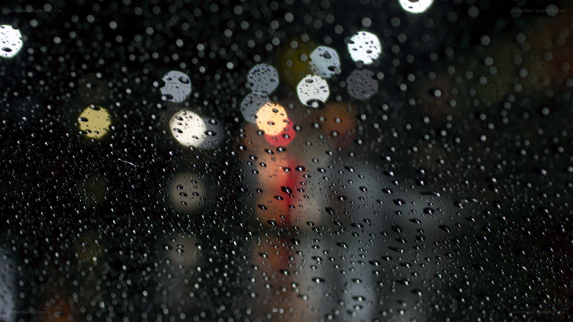Raindrops on a window at night