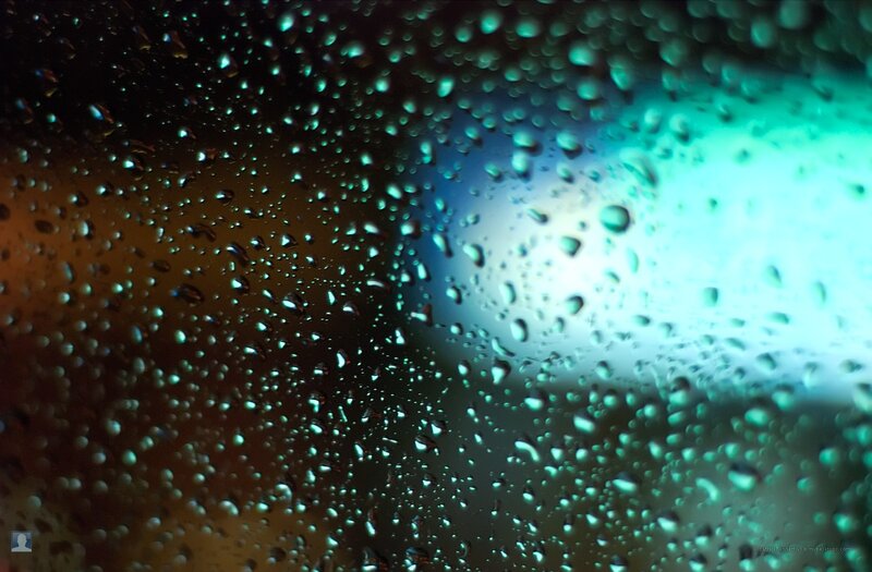 Raindrops on a window at night