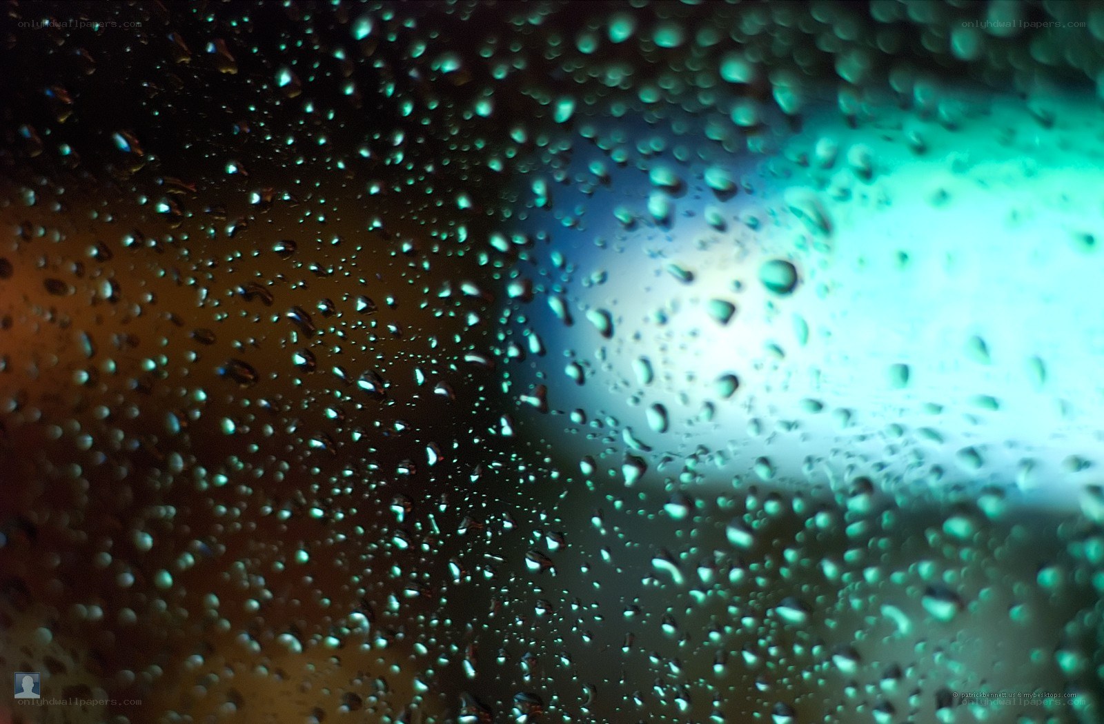 Raindrops on a window at night