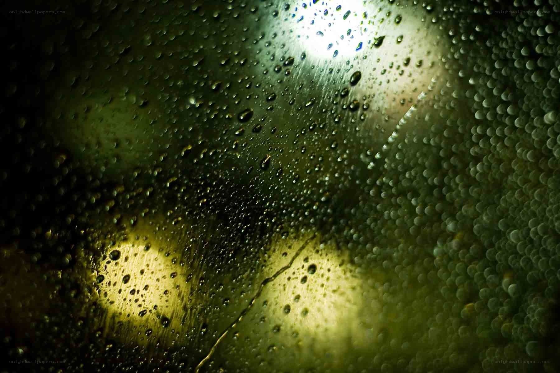 Raindrops on a window at night