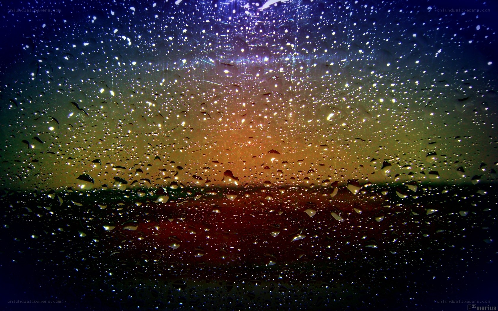 Raindrops on a window at sunset