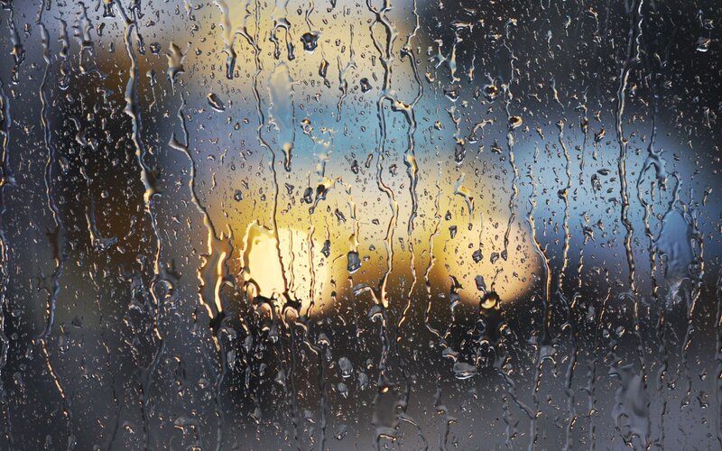 Raindrops on a window at sunset
