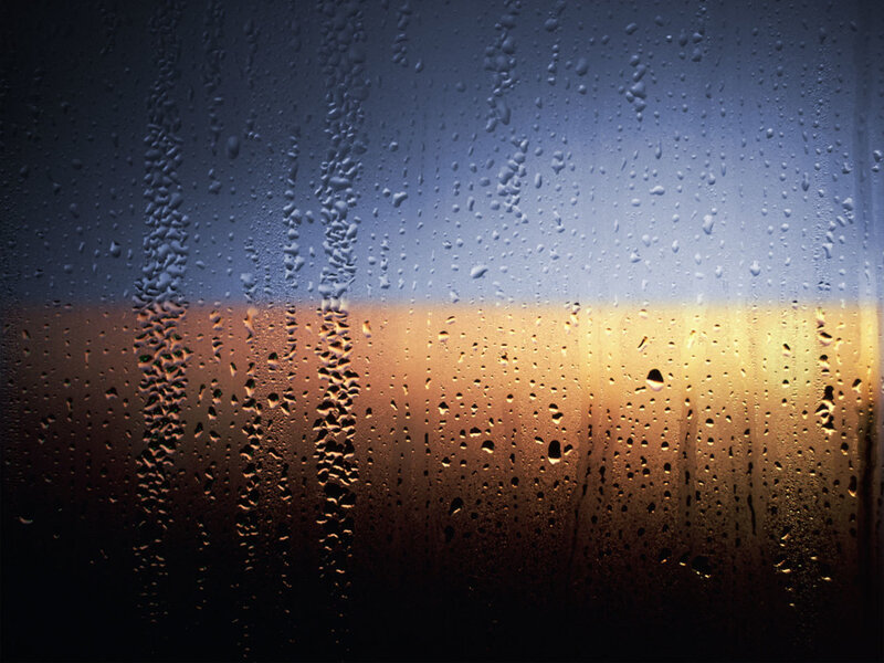 raindrops on a window at sunset