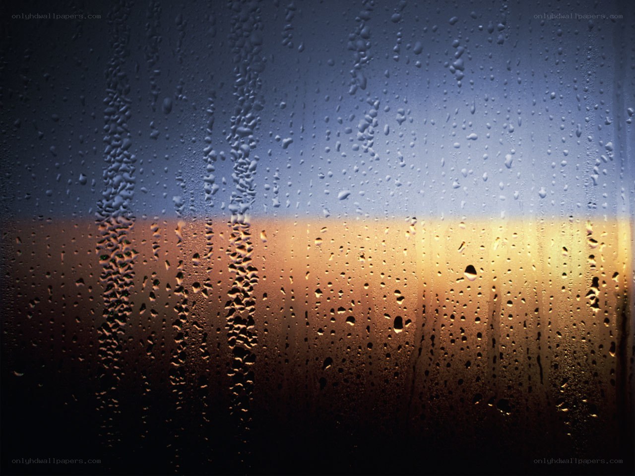 raindrops on a window at sunset