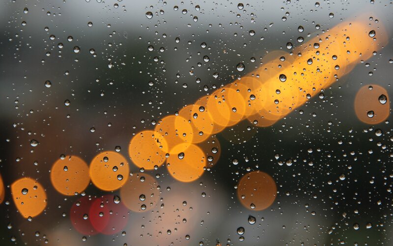 Raindrops on a window with bokeh lights