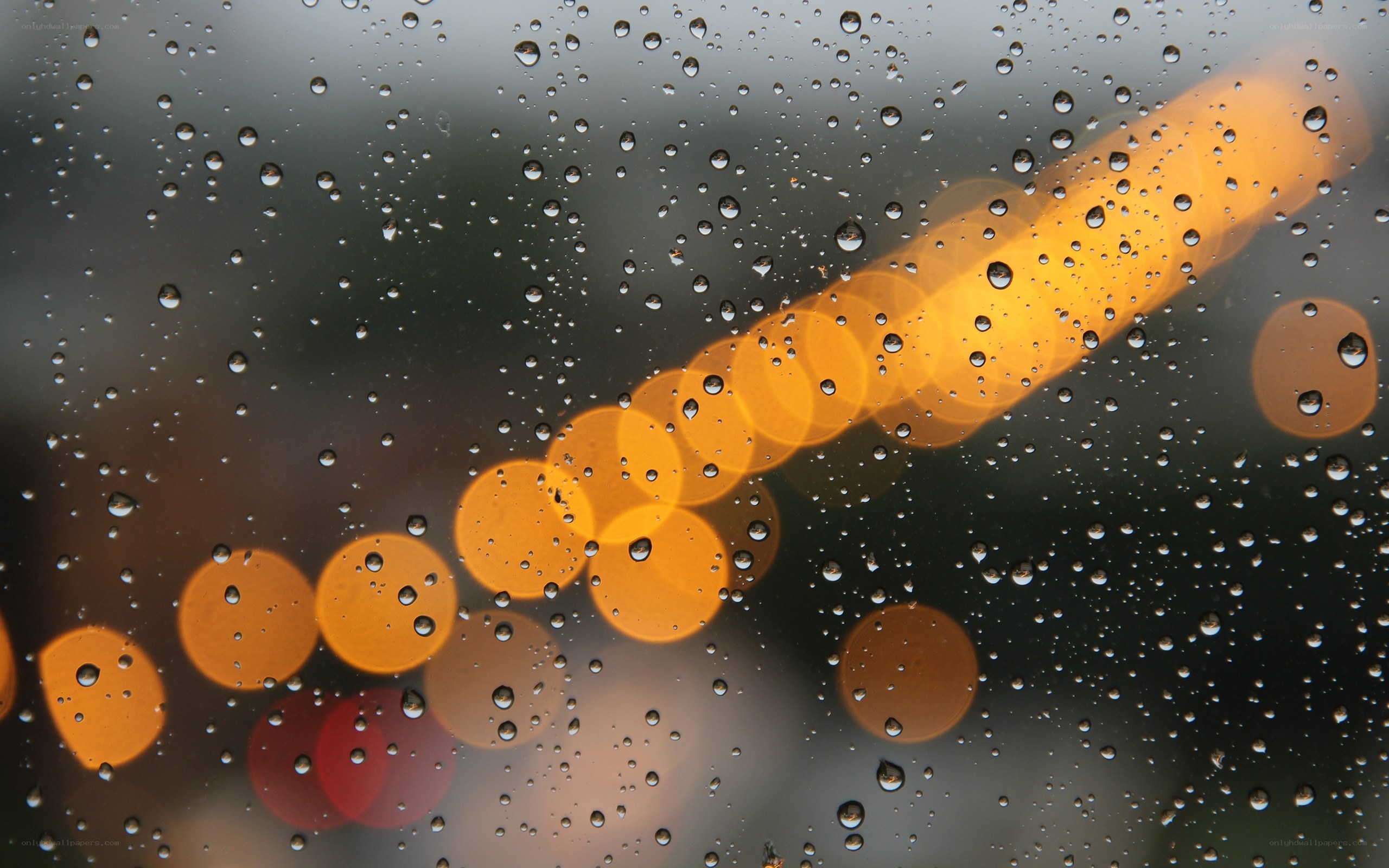 Raindrops on a window with bokeh lights