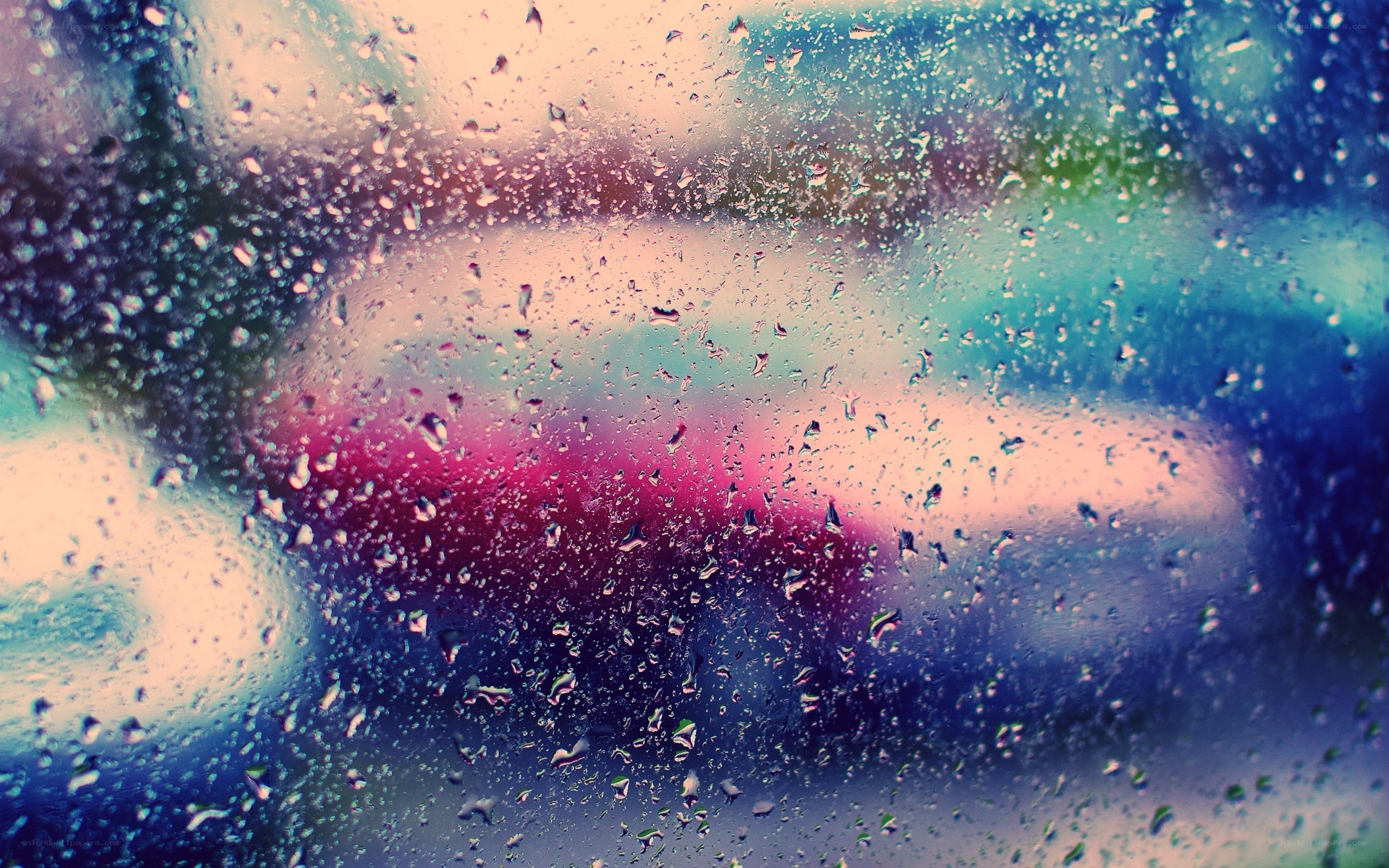 raindrops on a window with city lights