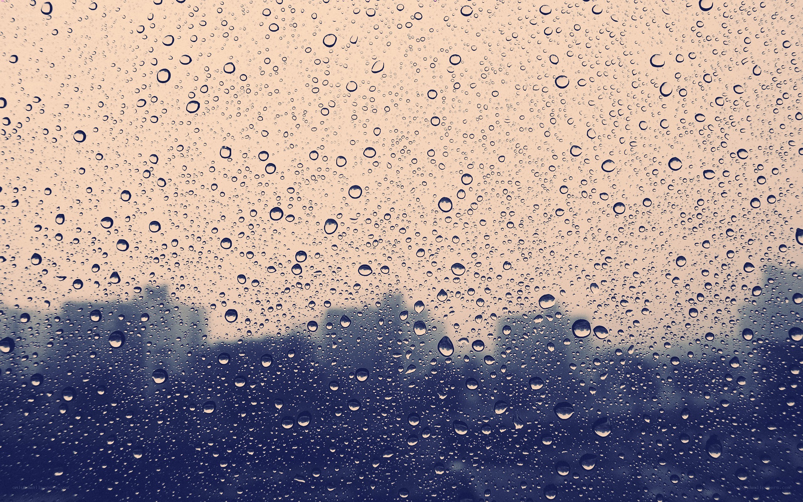 raindrops on a window with city view