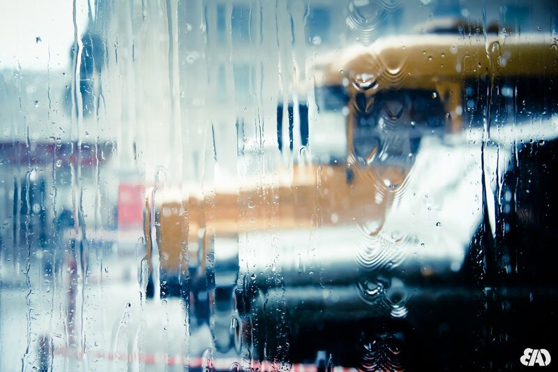 Raindrops on a window with city view