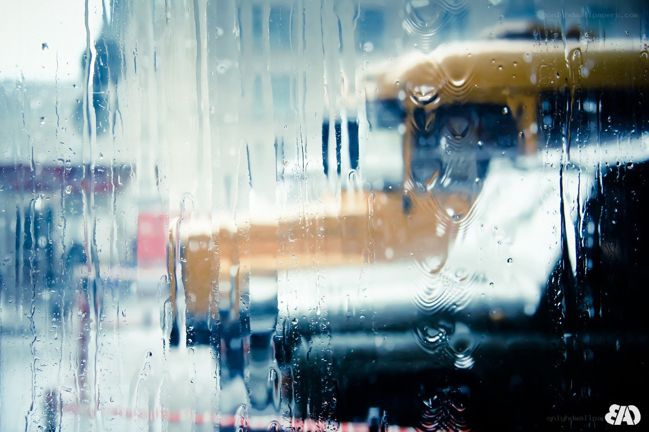 Raindrops on a window with city view