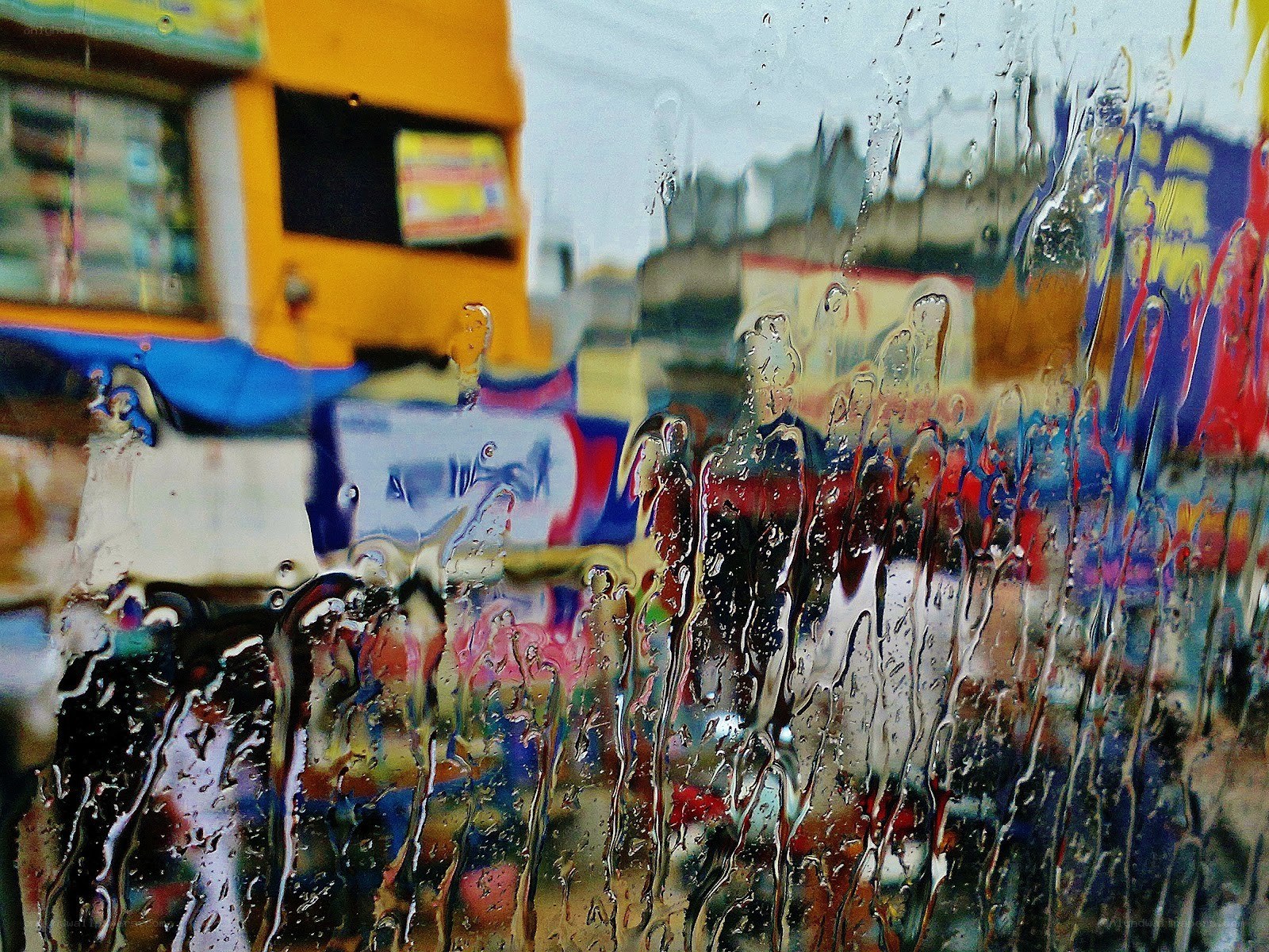 Raindrops on a window with city view