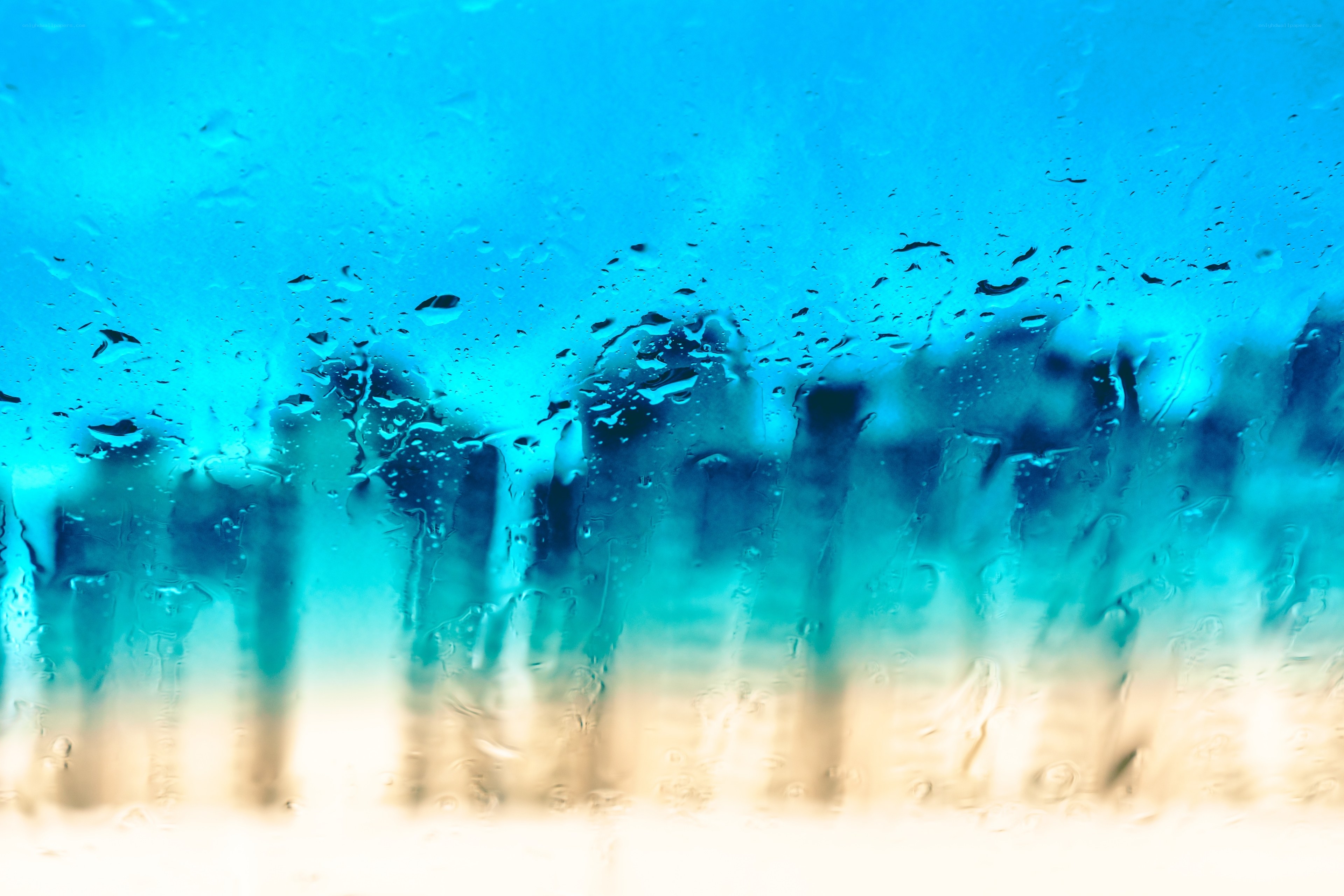 Raindrops on a window with city view