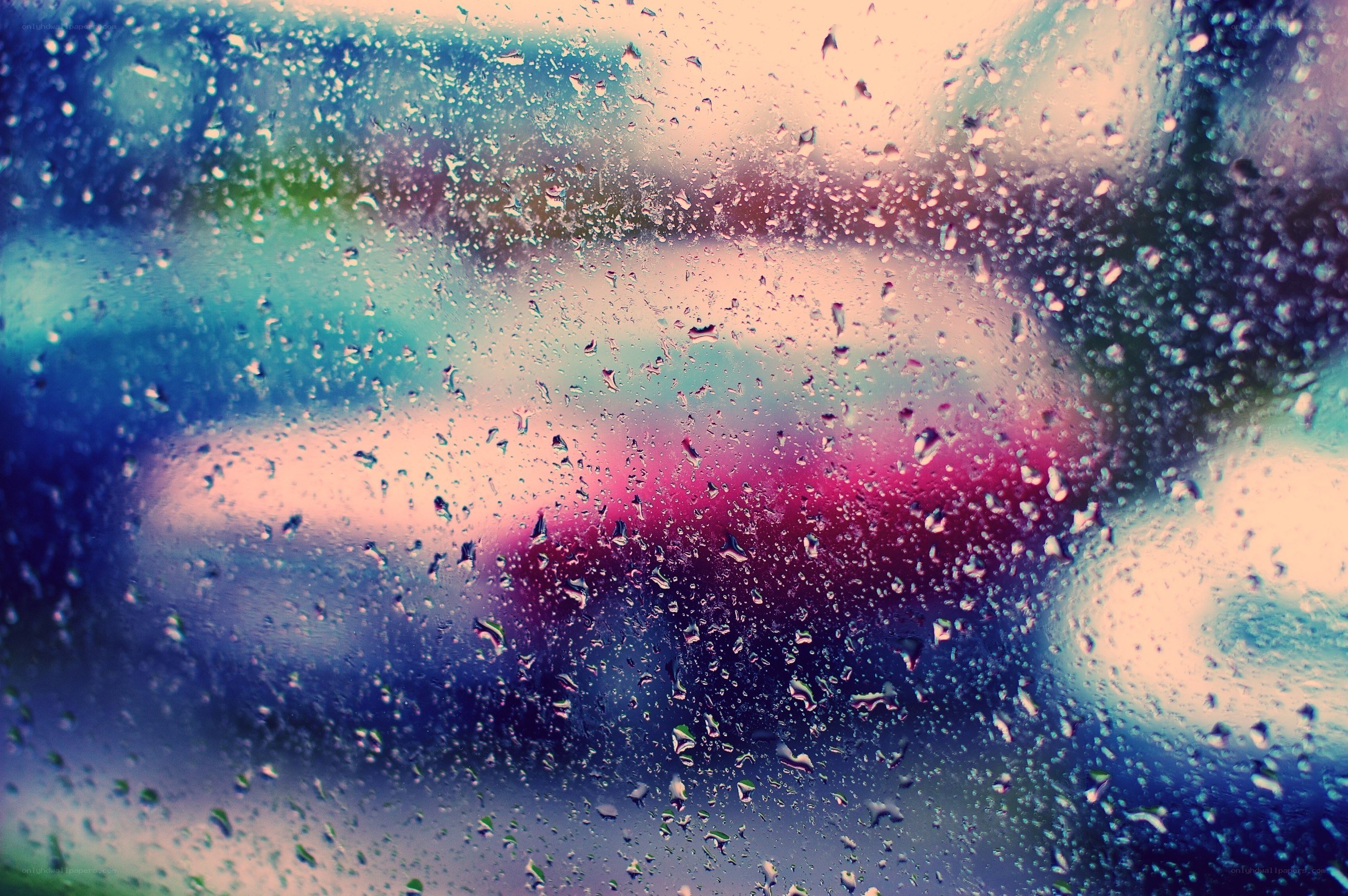 raindrops on a window with colorful lights