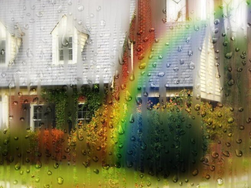 Raindrops on a window with rainbow