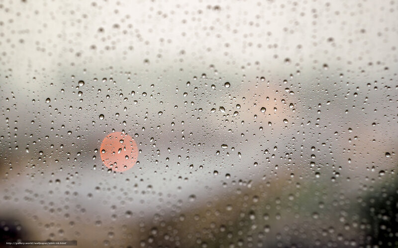 Raindrops on a window with sunset
