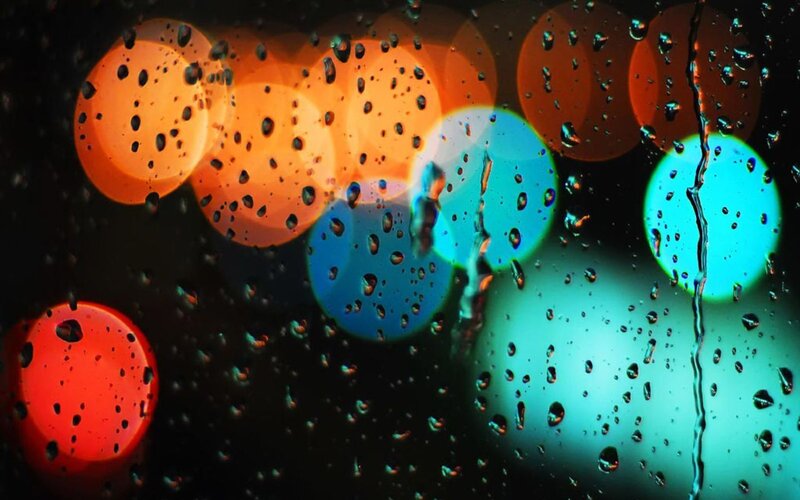 raindrops on glass with bokeh lights