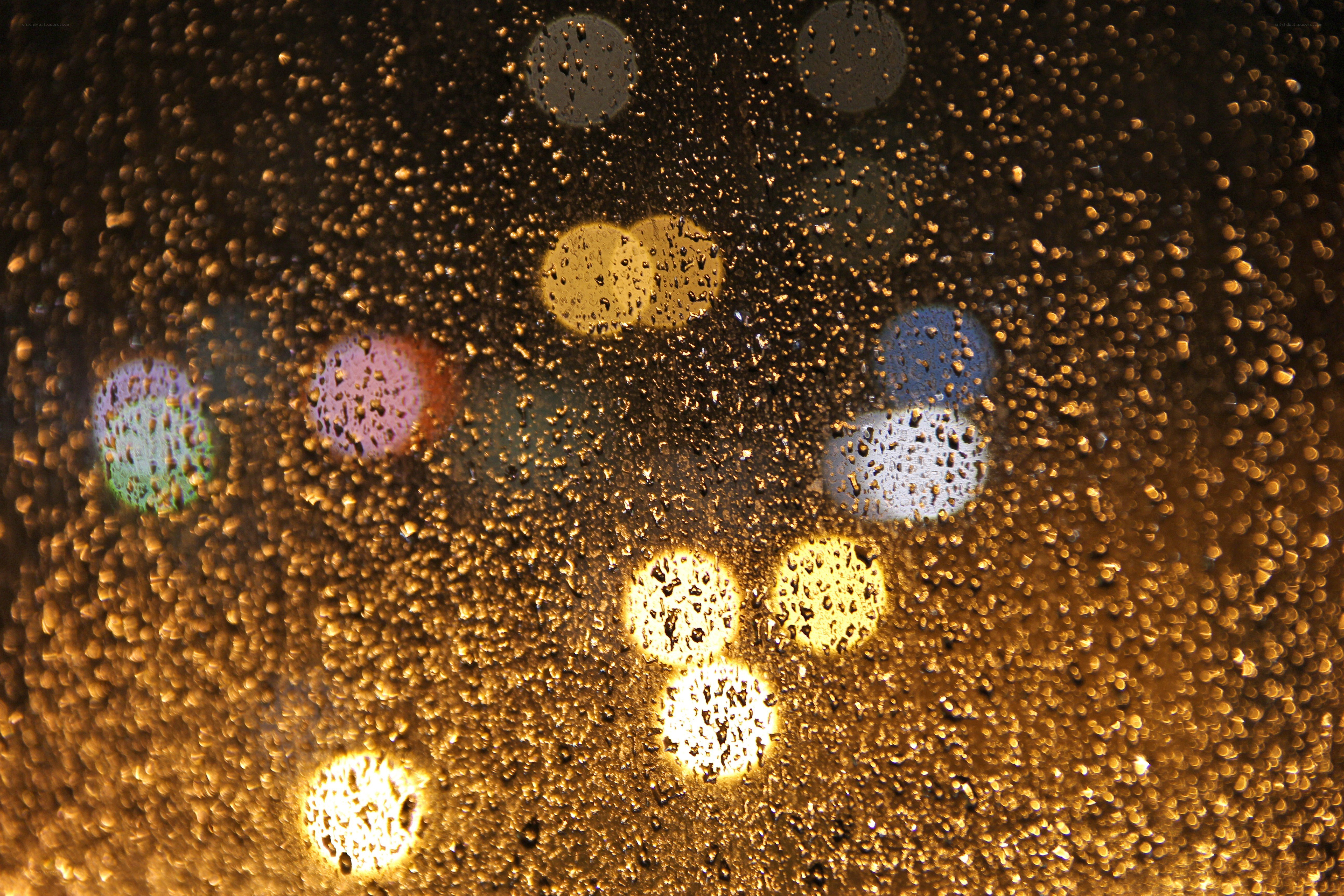 raindrops on glass with bokeh lights