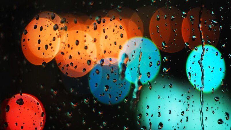 raindrops on glass with city lights