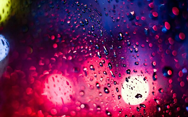 raindrops on glass with colorful lights