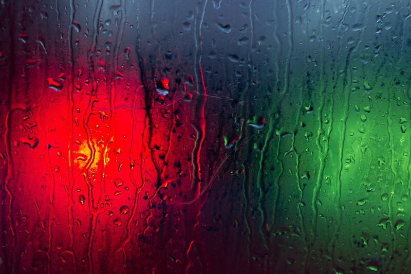 raindrops on glass with red and green lights