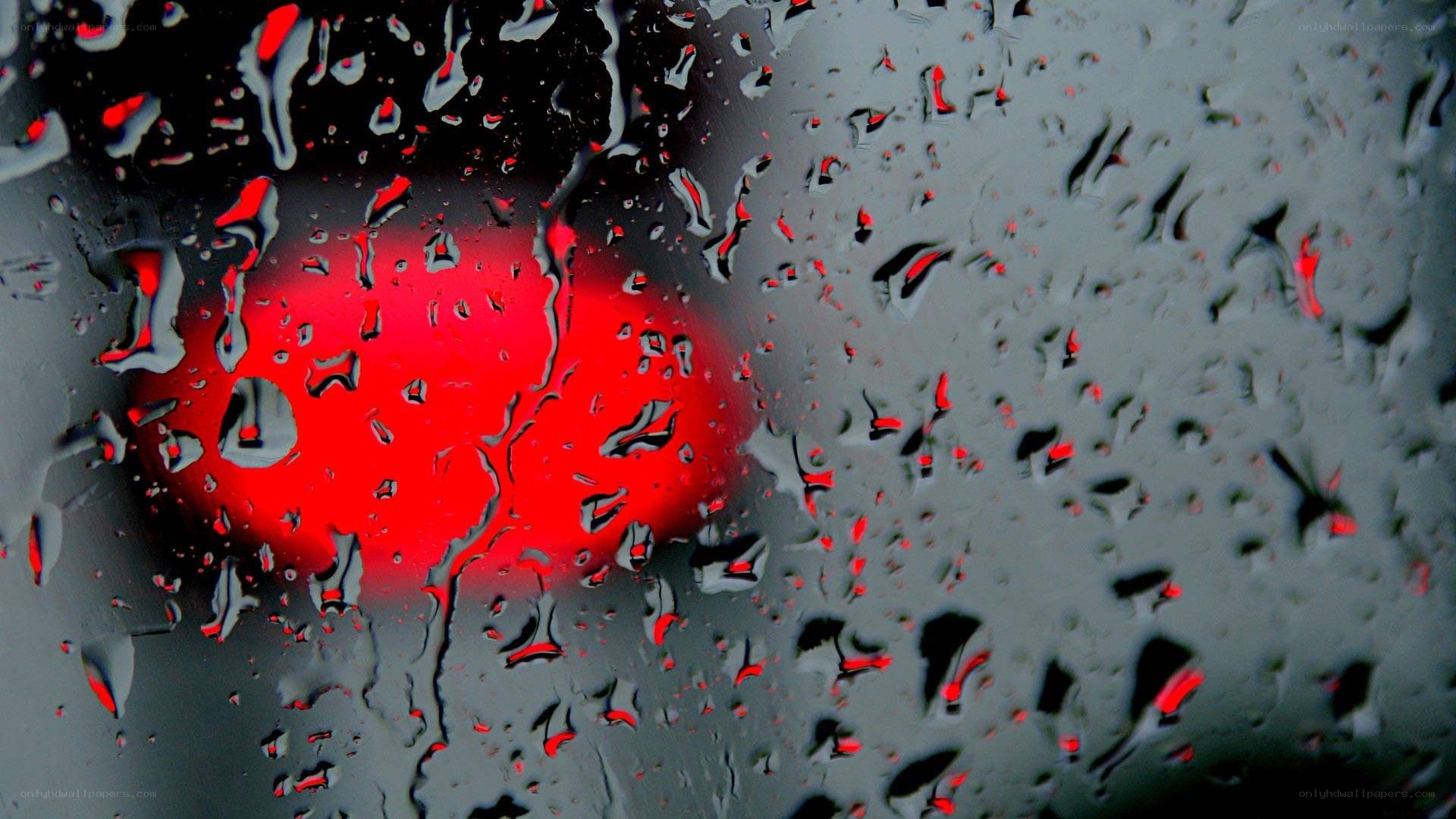 raindrops on glass with red light