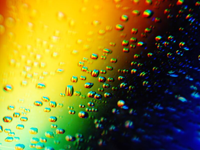 Raindrops on Reflective Surface — Yellow
