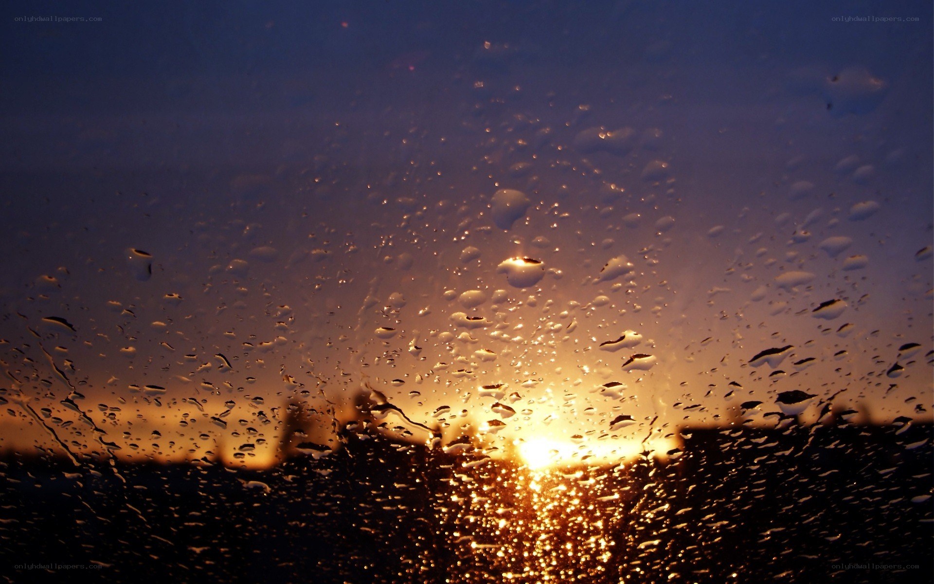 raindrops on window at sunset