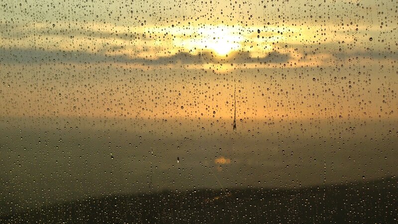 raindrops on window at sunset